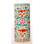 A late 20th Century Chinese cylindrical vase decorated with stylised flowers, radishes and bats,