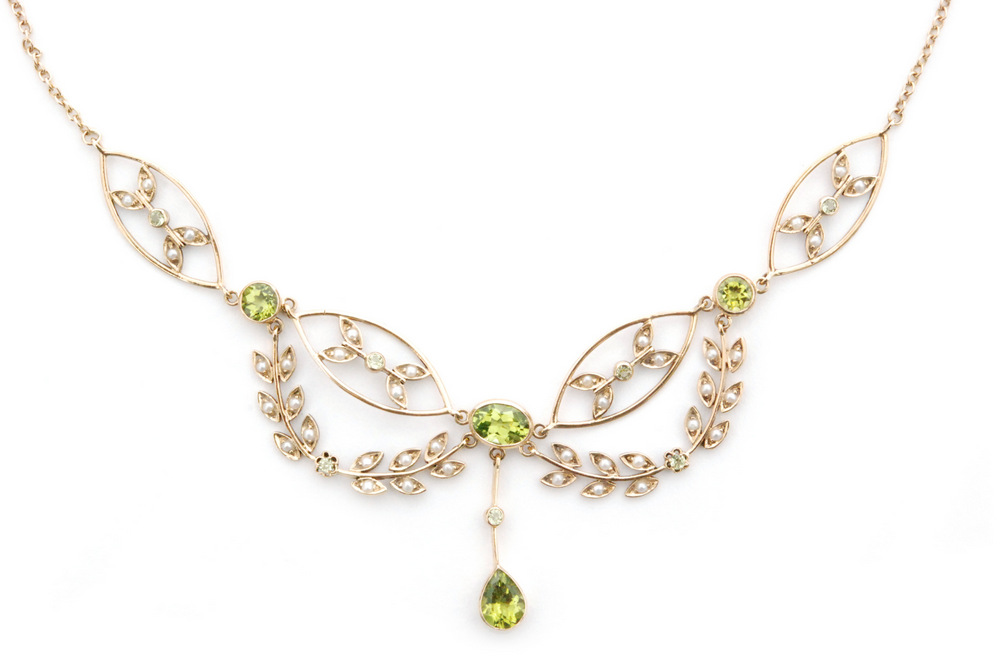 An Edwardian style 9ct seed pearl and peridot necklet designed as foliate sprays inset with