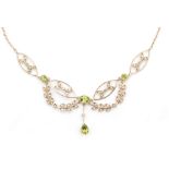 An Edwardian style 9ct seed pearl and peridot necklet designed as foliate sprays inset with