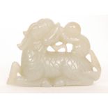 A Chinese celadon jade carving of a recumbent dragon or qilin with carved scaly body,