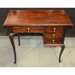A small Victorian mahogany kneehole desk with single frieze drawer and three short drawers to the