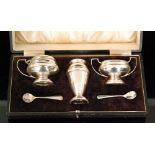 A hallmarked silver cased three piece pedestal cruet set of plain form, Sheffield 1917,