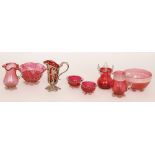 A group of late 19th Century Cranberry glass comprising a cream jug in white metal mounts with