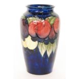 A William Moorcroft Wisteria pattern vase of shouldered form decorated with a band of plums,