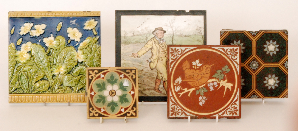 Five assorted late 19th Century tiles comprising a Minton 8 inch dust pressed tile decorated with a