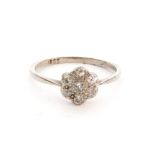 An early 20th Century 18ct white gold diamond daisy cluster ring seven old cut stones to knife