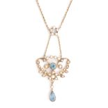 An early 20th Century seed pearl and aquamarine openwork pendant,