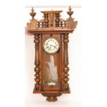 A late 19th Century walnut cased regulator wall clock with spring driven movement enclosed by a
