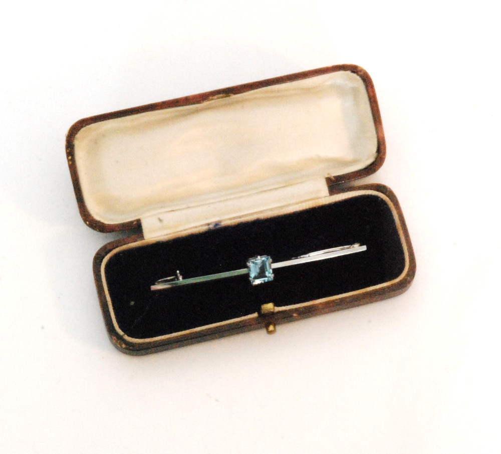 A platinum and aquamarine bar brooch,