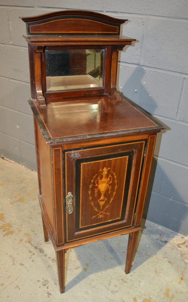A late Victorian mahogany and part ebonised marquetry inlaid pot cupboard enclosed by an urn and