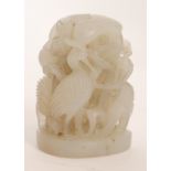 A Chinese celadon jade carving of domed form depicting four standing cranes sheltering amidst