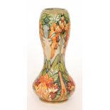 A boxed Moorcroft Pottery vase decorated in the Flame of the Forest pattern designed by Philip