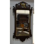 A Georgian style wall mirror with a mahogany pierced fretwork frieze,
