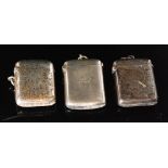 Three hallmarked silver cushioned rectangular vesta cases, two plain,