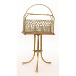 An Edwardian brass three divisioned magazine rack, width 35cm.