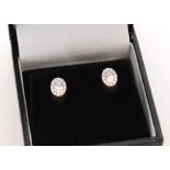 A pair of 18ct white gold diamond cluster earrings,