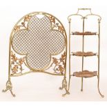 An Edwardian brass arch shaped firescreen with acorn and leaf corner detail and a three tier brass