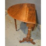 A Victorian oval walnut drop flap Sutherland table on turned scroll ends united by a turned