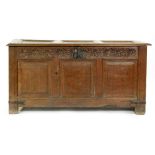 An 18th Century carved oak coffer,