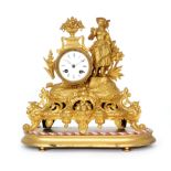 A 19th Century French pressed gilt metal mantle clock mounted with a farm girl holding a rake above