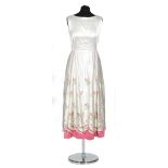 A 1950s ladies vintage dress in ivory satin with a full circle skirt,