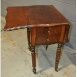 A 19th Century mahogany drop flap work table with butterfly shaped top on reeded legs and castors,