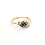 A mid 20th Century sapphire and diamond three stone ring, central sapphire flanked by a diamond,