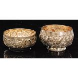 Two hallmarked silver small circular bowls each with embossed foliate decoration to whole,