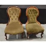 A pair of Victorian carved walnut easy chairs upholstered in pale green plush,