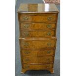 A small Queen Anne style figured bowfront walnut tallboy of seven drawers,