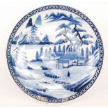 A large late 19th to early 20th Century Japanese export charger decorated in blue and white with