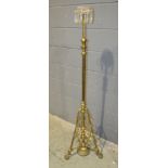 A late Victorian brass standard lamp with clear crystal tier drop on pierced aesthetic style base