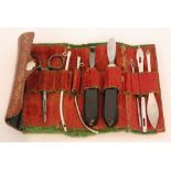An early 19th Century red leather roll opening to reveal nine assorted implements to include