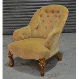 A Victorian easy chair with oatmeal coloured button down upholstery over walnut scroll carved