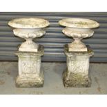 A pair of 19th Century small cast iron terrace urns of waisted acanthus form,