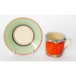 A Clarice Cliff Tankard shape coffee can and saucer decorated in the Orange Lily pattern,