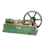 A green painted cast iron model of a steam engine, with single oscillating piston, width 26cm.