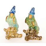 Two continental model parrots each glazed in green with blue feathered plumes,