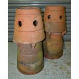 A pair of terracotta conical shaped chimney pots,