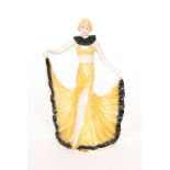 A 1930s Art Deco model of a dancing girl dressed in a yellow croplet,