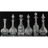 A group of 19th Century and later clear glass decanters comprising a heavily facet cut example,