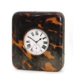 An early 20th Century tortoiseshell bedside clock case with lever fob watch