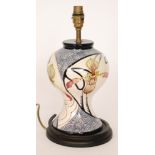 A Black Ryden table lamp decorated with hand painted orchids within blue whiplash lines and blue