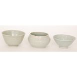 Three studio pottery footed bowls each in a celadon glaze with incised decoration,