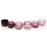 A group of seven 19th Century and later amethyst glass finger bowls comprising three plain examples,