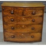 A 19th Century bow fronted chest of two short over three long drawers, with turned handles,