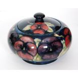 A William Moorcroft Pansy pattern powder box and cover,