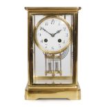 A 20th Century brass bevelled cased mantle clock with circular white enamelled dial and mercury