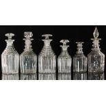 A group of six 19th Century clear glass decanters, each with varying pillar cut decoration,