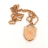 A 9ct hallmarked rose gold shield shaped locket with foliate engraved decoration, Birmingham 1916,